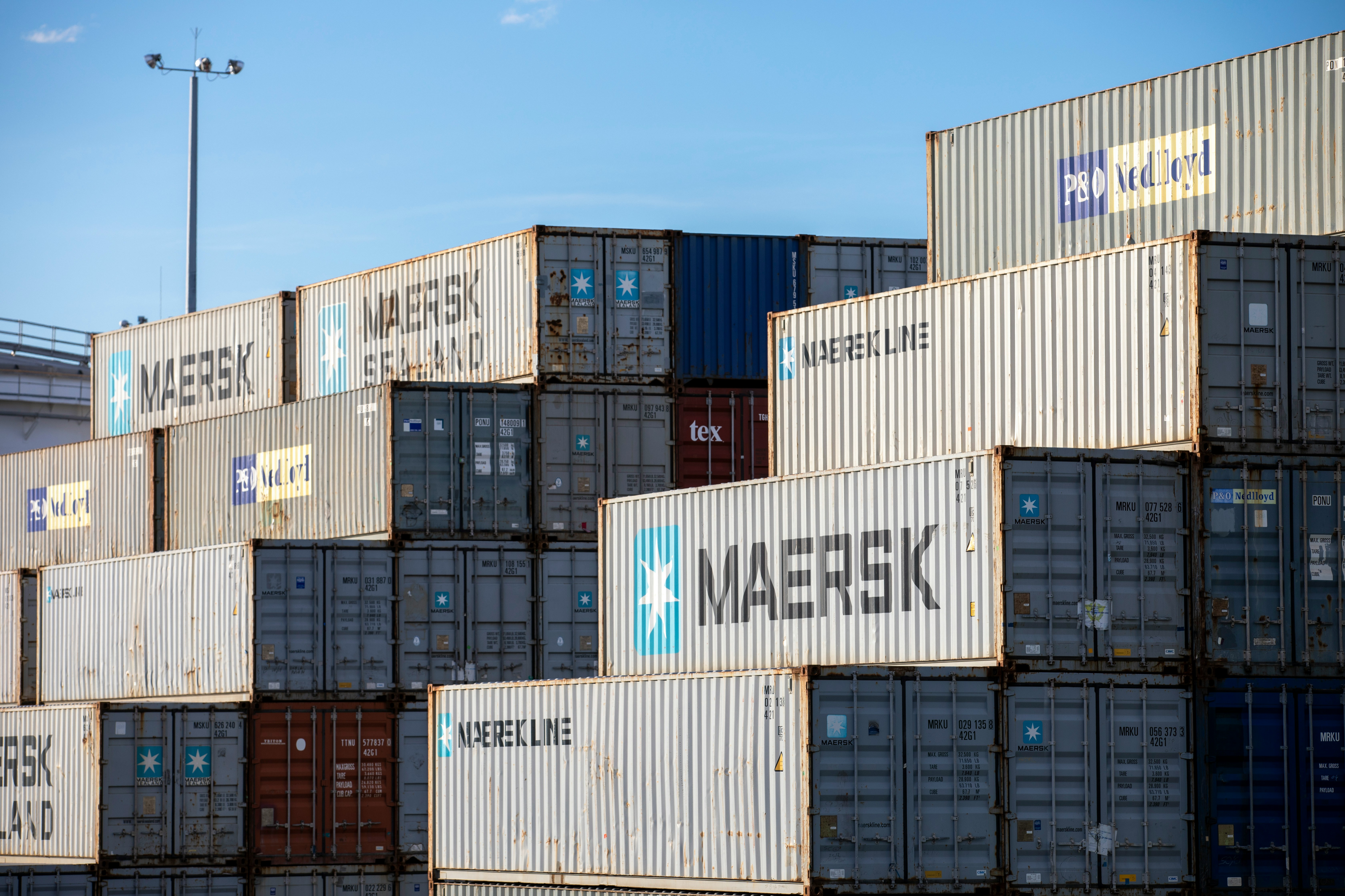 A wall of stacked shipping containers