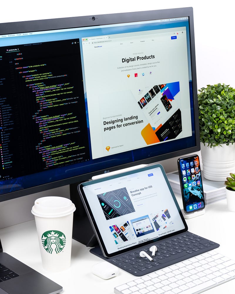 Image of computer monitor, mobile phone, and a cup of starbucks.